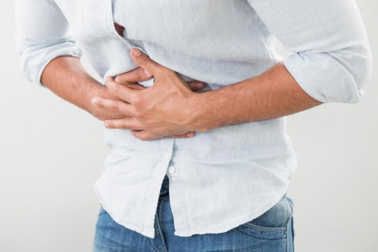 person holding stomach in pain