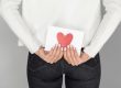 woman holding love envelope back view
