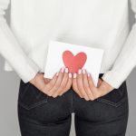 woman-holding-love-envelope-back-view-scaled